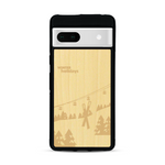 Coque de protection en bois véritable fabriquée en France pour  sur le thème de la montagne, du ski et de la neige avec un motif représentant une paire de ski plantée dans la neige avec en fond des montagnes enneigées