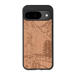 Coque de protection en bois véritable fabriquée en France pour Google Pixel 8pro sur le thème de la randonnée en montagne et de l'aventure avec une gravure représentant une femme de dos face à un paysage de nature