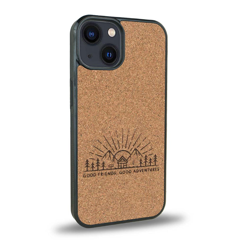 Coque de protection en bois véritable fabriquée en France pour iPhone 15 Plus sur le thème chill et nature avec un motif représentant un levé de soleil sur un paysage de montagne avec des sapins et un chalet et la phrase "Good friends, good adventure"