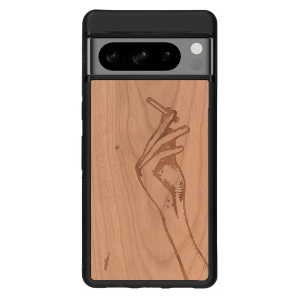 Coque de protection en bois véritable fabriquée en France pour Google Pixel 6 représentant une main de femme tenant une cigarette de type line art en collaboration avec l'artiste Maud Dabs