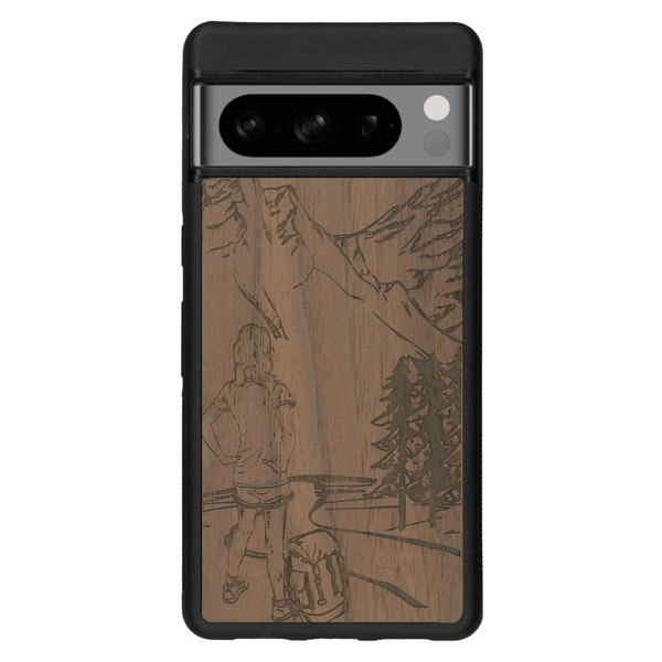 Coque de protection en bois véritable fabriquée en France pour Google Pixel 6 sur le thème de la randonnée en montagne et de l'aventure avec une gravure représentant une femme de dos face à un paysage de nature