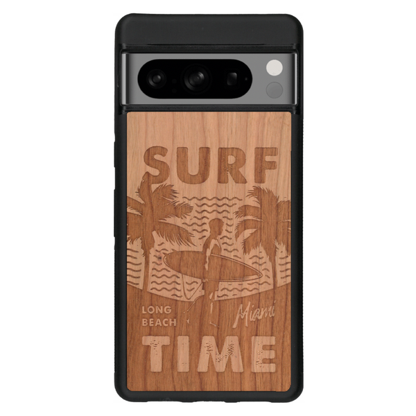 Coque de protection en bois véritable fabriquée en France pour Google Pixel 7 sur le thème chill avec un motif représentant une silouhette tenant une planche de surf sur une plage entouré de palmiers et les mots "Surf Time Long Beach Miami"