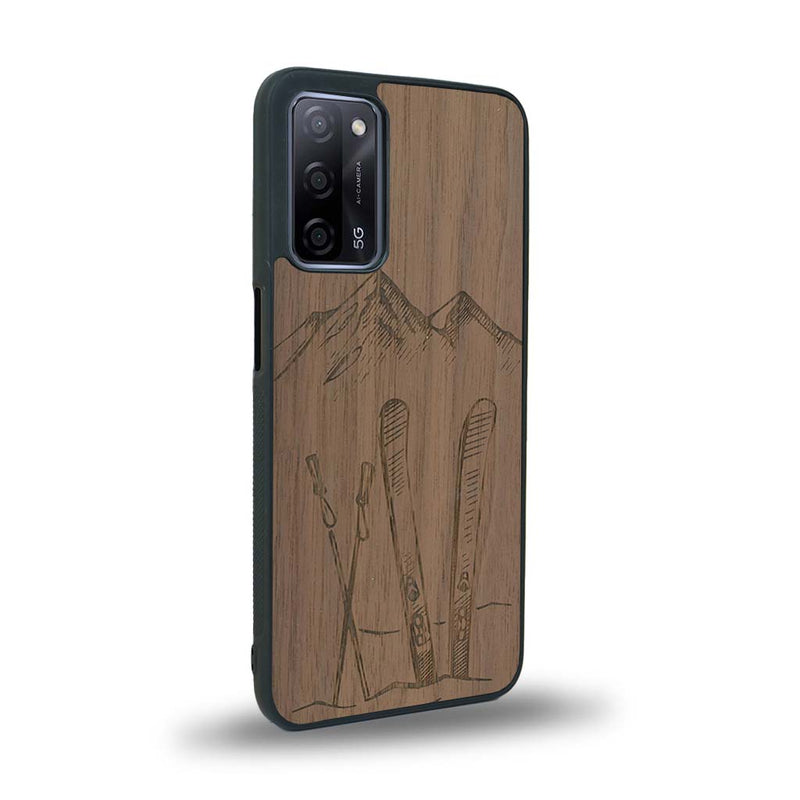 Coque de protection en bois véritable fabriquée en France pour Oppo A72 sur le thème de la montagne, du ski et de la neige avec un motif représentant une paire de ski plantée dans la neige avec en fond des montagnes enneigées