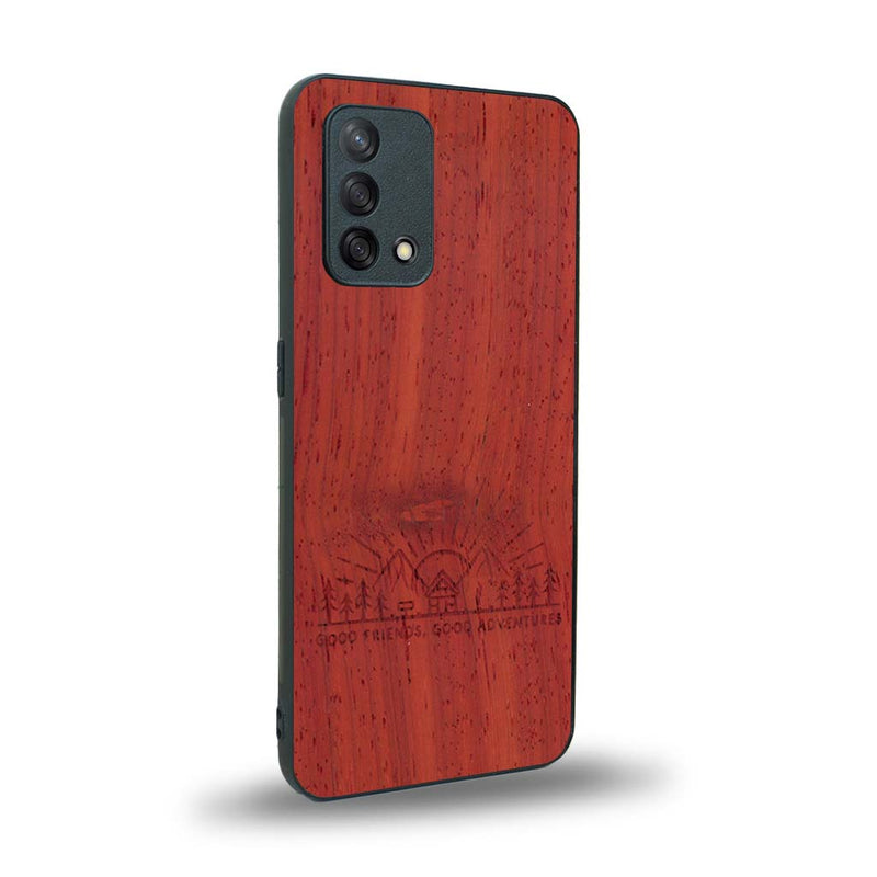 Coque de protection en bois véritable fabriquée en France pour Oppo A74 4G sur le thème chill et nature avec un motif représentant un levé de soleil sur un paysage de montagne avec des sapins et un chalet et la phrase "Good friends, good adventure"