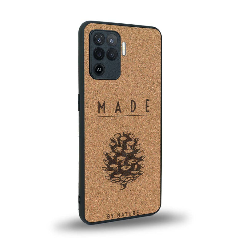 Coque de protection en bois véritable fabriquée en France pour Oppo A94 sur le thème de la nature et des arbres avec une gravure représentant une pomme de pin et la phrase "made by nature"