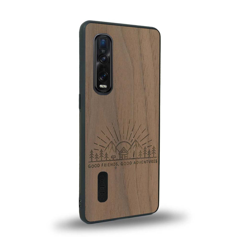 Coque de protection en bois véritable fabriquée en France pour Oppo Find X2 Pro sur le thème chill et nature avec un motif représentant un levé de soleil sur un paysage de montagne avec des sapins et un chalet et la phrase "Good friends, good adventure"