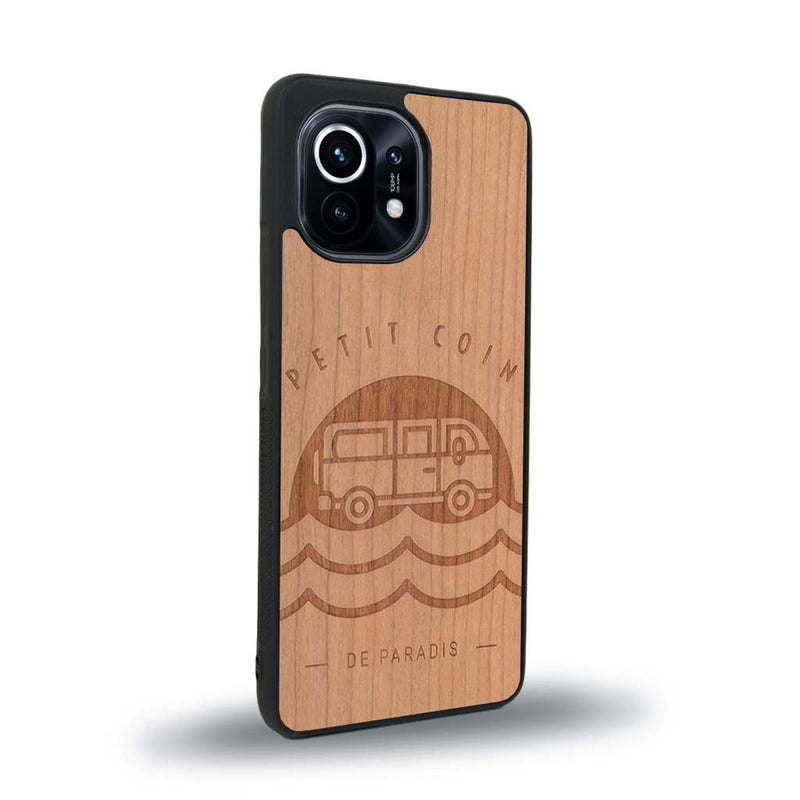 Coque de protection en bois véritable fabriquée en France pour Xiaomi Mi 11 Lite sur le thème des voyages en vans, vanlife et chill avec une gravure représentant un van vw combi devant le soleil couchant sur une plage avec des vagues