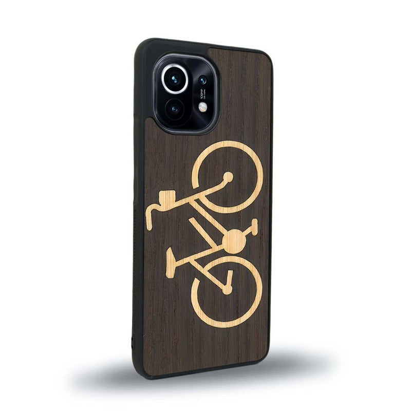 Coque de protection en bois véritable fabriquée en France pour Xiaomi Mi 11 Lite sur le theme du vélo et de l'outdoor qui allie du bambou et du chêne fumé représentant un vélo