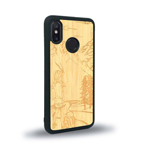 Coque de protection en bois véritable fabriquée en France pour Xiaomi Mi 8 sur le thème de la randonnée en montagne et de l'aventure avec une gravure représentant une femme de dos face à un paysage de nature