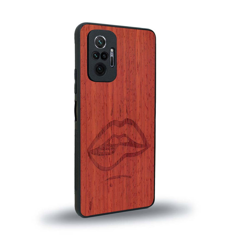 Coque de protection en bois véritable fabriquée en France pour Xiaomi Redmi Note 10 Pro représentant de manière minimaliste une bouche de féminine se mordant le coin de la lèvre de manière sensuelle dessinée à la main par l'artiste Maud Dabs