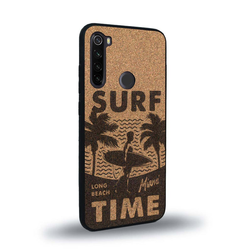 Coque de protection en bois véritable fabriquée en France pour Xiaomi Redmi Note 8 sur le thème chill avec un motif représentant une silouhette tenant une planche de surf sur une plage entouré de palmiers et les mots "Surf Time Long Beach Miami"