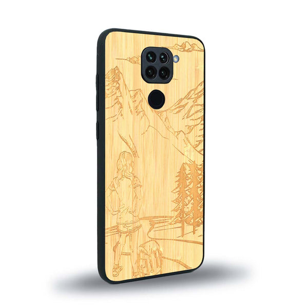 Coque de protection en bois véritable fabriquée en France pour Xiaomi Redmi Note 9 sur le thème de la randonnée en montagne et de l'aventure avec une gravure représentant une femme de dos face à un paysage de nature